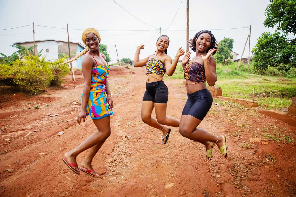 Three young people smiling while jumping in the air